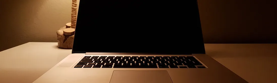 Notebook, glasses, and a cup of tea on a desk